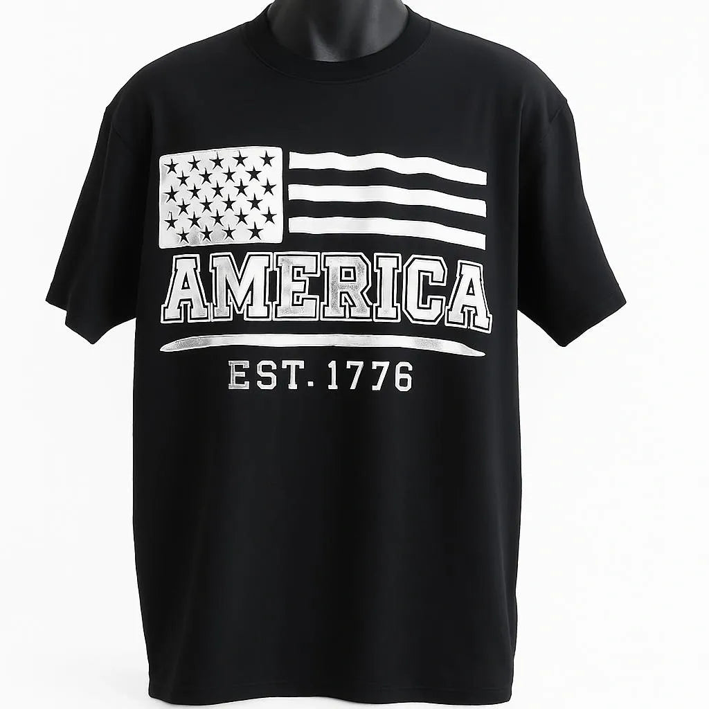 Black short sleeve graphic t shirt featuring a distressed American flag design with America EST 1776 text in a vintage patriotic style.