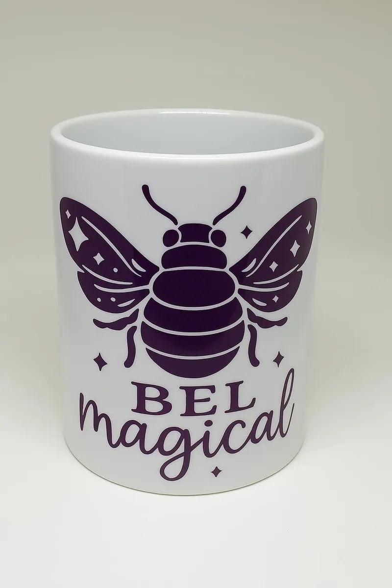 White ceramic mug with purple bee illustration and Bee Magical text, inspirational bee coffee mug, whimsical tea cup for daily use at home or office