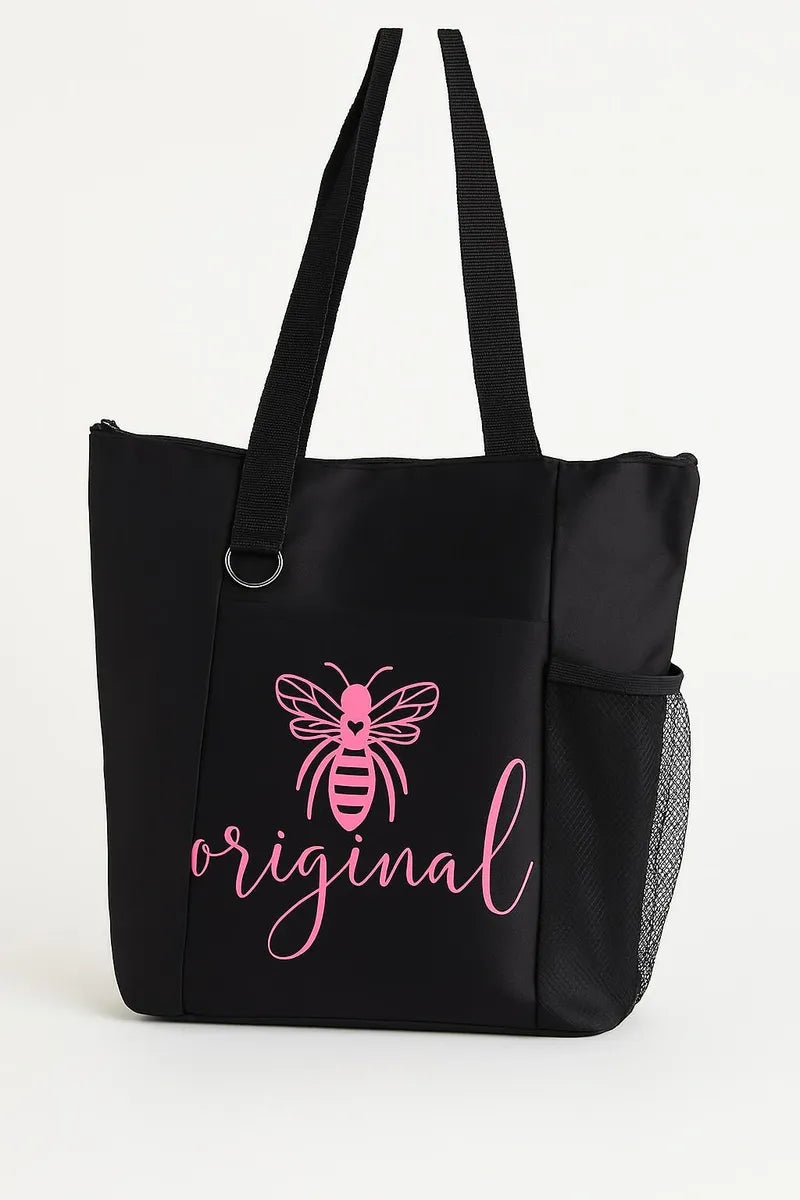 Black tote bag with pink Bee Original text and bee illustration, reusable fabric shoulder bag on white background
