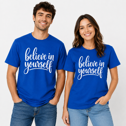 A man and a woman standing side by side wearing matching royal blue t-shirts with the phrase 'believe in yourself' printed in white script across the chest, paired with blue jeans against a light gray studio background.