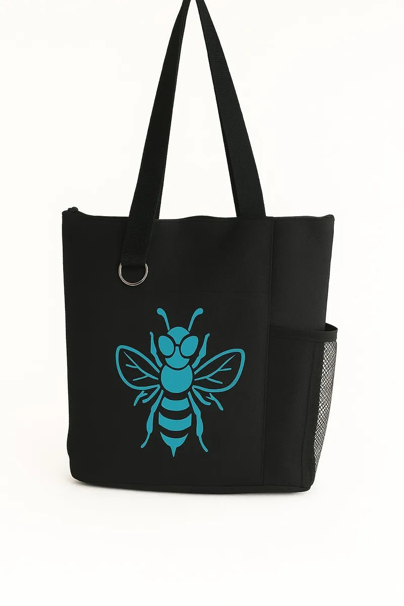 Black reusable tote bag featuring a teal bee graphic design on the front. Lightweight shoulder tote with long handles for comfortable carrying. Perfect for shopping, books, work, travel, errands, farmers markets, and everyday use. Stylish nature-inspired bee artwork adds a modern touch to this practical carryall bag. Ideal for women, students, teachers, gardeners, bee lovers, and eco-conscious shoppers seeking a fashionable and functional tote bag.