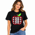 Woman wearing a black checkered apple graphic T-shirt with red apple and green leaf design.
