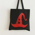 Black cotton tote bag with bright red witch hat graphic design, reusable Halloween shoulder bag for shopping, school, travel, spooky season fashion, and witchy aesthetic accessories.