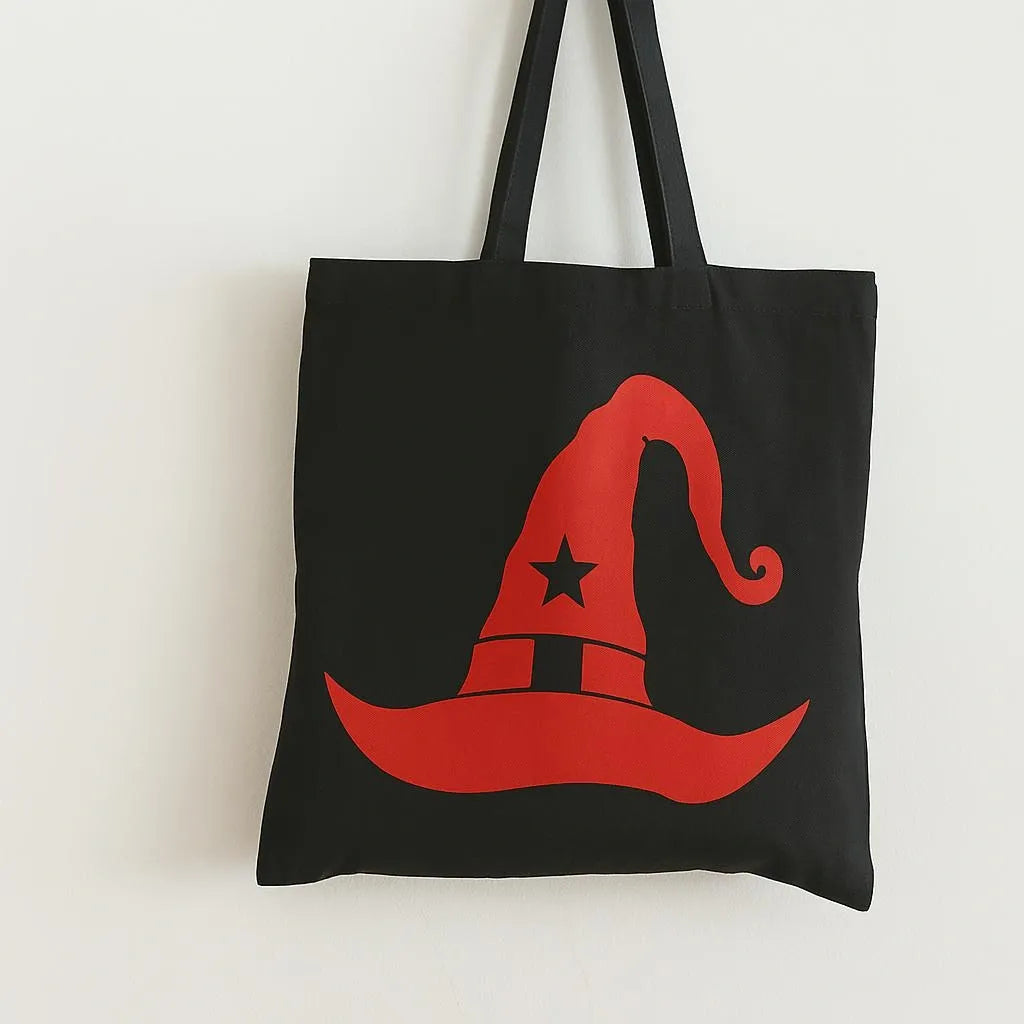 Black cotton tote bag with bright red witch hat graphic design, reusable Halloween shoulder bag for shopping, school, travel, spooky season fashion, and witchy aesthetic accessories.