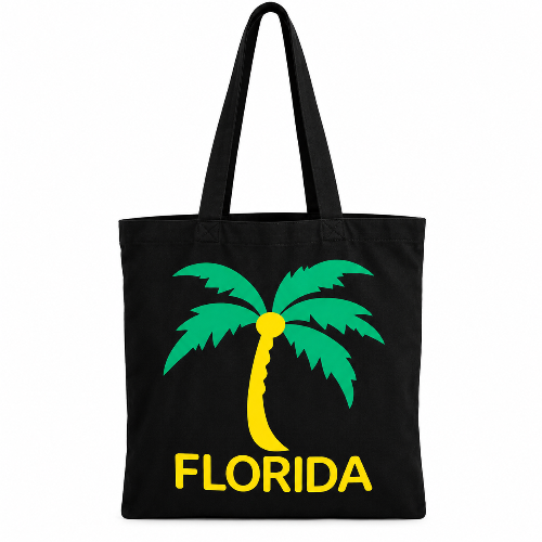 Black tote bag with green and yellow Florida palm tree design and long shoulder straps on a white background.