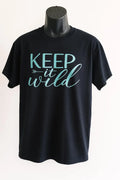 Black graphic t shirt featuring the phrase Keep Wild in bold stylish lettering, celebrating freedom, adventure, nature, and independent living.