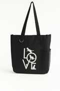 Black tote bag featuring a white LOVE script design on the front. Lightweight reusable shoulder tote with long handles for comfortable carrying. Ideal for shopping, work, books, errands, travel, school, gifts, and everyday use. Simple minimalist fashion accessory with a modern black and white design that pairs easily with casual outfits. Durable tote bag suitable for women, teens, students, teachers, and anyone looking for a stylish and practical everyday carry bag.