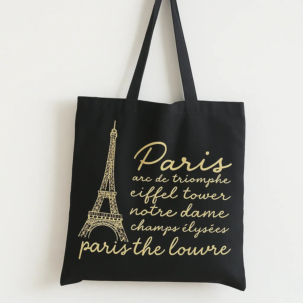 Shop the Black Paris Eiffel Tower Tote Bag with elegant gold Paris artwork on durable cotton. Perfect for shopping, travel, school, and stylish everyday use.