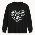 Black long sleeve shirt featuring a white heart made of paw prints, pet lover graphic shirt for dog lovers, cat lovers, animal rescue supporters, and everyday casual wear