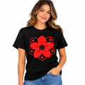 A woman wearing a black short-sleeve t-shirt with a large red mandala-style flower graphic on the front, paired with blue jeans, against a plain white background.