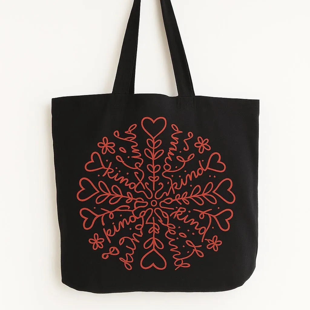 Black cotton tote bag with red snowflake heart design, reusable winter tote bag for shopping, travel, holiday errands, Christmas season, cozy winter fashion, everyday carry bag with festive snowflake artwork and long shoulder straps