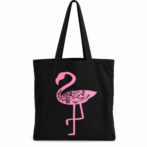 Black cotton tote bag with pink floral flamingo design and long shoulder straps on a white background.