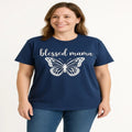 Woman wearing a navy blue “Blessed Mama” graphic T-shirt with a butterfly design and casual jeans against a light background