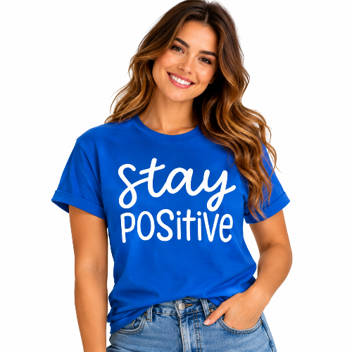 Woman wearing a blue Stay Positive graphic T-shirt with large white lettering.