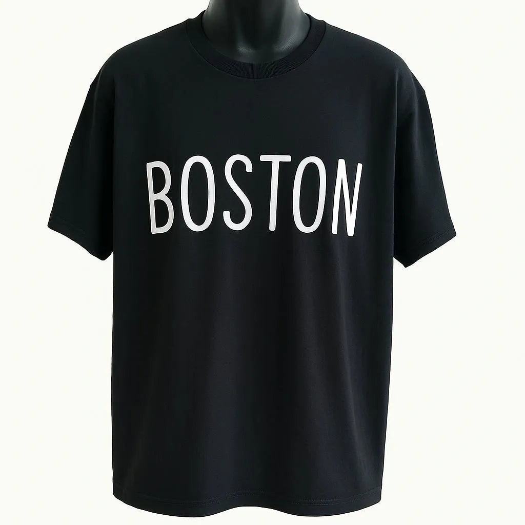 Black graphic t-shirt featuring the word "Boston" in clean white typography, stylish unisex city-inspired graphic tee for casual everyday wear.