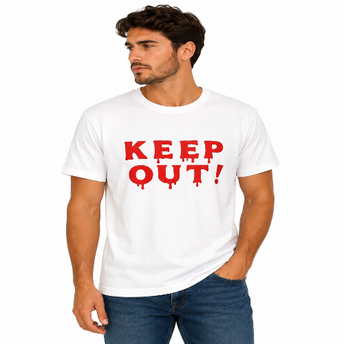 A man wearing a white crewneck t-shirt with 'KEEP OUT!' printed in a dripping red font, paired with blue jeans, against a plain white background.