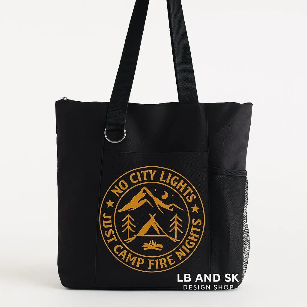 Black tote bag featuring a city and mountain emblem design in gold tones. Reusable shoulder tote bag for shopping, work, school, travel, books, groceries, and everyday errands. Lightweight and durable carryall with comfortable straps and an outdoor-inspired graphic. Perfect for travelers, hikers, campers, outdoor enthusiasts, and lovers of modern adventure-themed accessories.