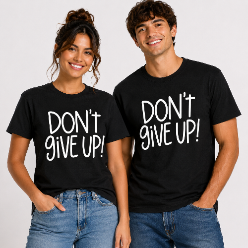 Male and female models wearing matching black unisex “Don’t Give Up!” graphic T-shirts with bold white lettering.