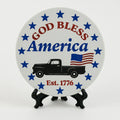 Patriotic coaster featuring God Bless America text, stars, American flag accents, and a vintage truck design in red, white, and blue colors.