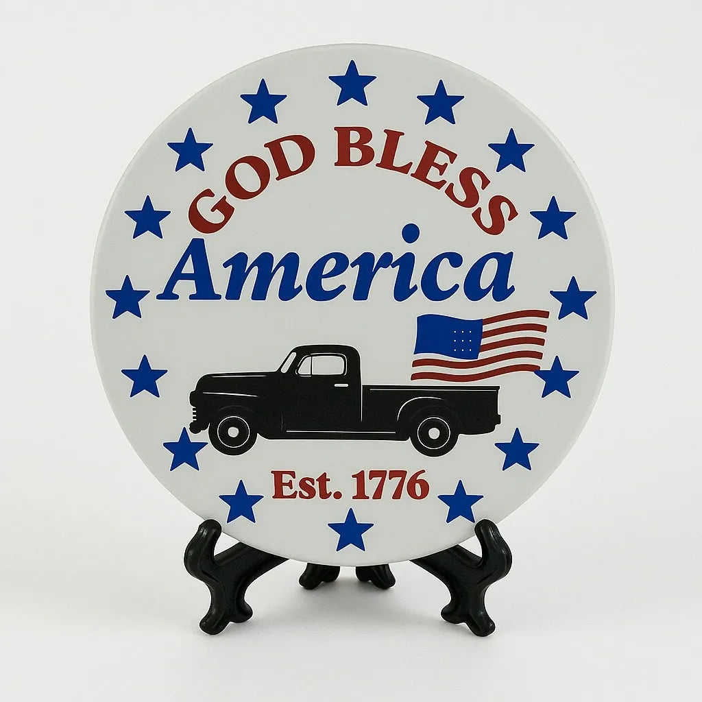 Patriotic coaster featuring God Bless America text, stars, American flag accents, and a vintage truck design in red, white, and blue colors.