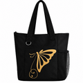 Black reusable tote bag featuring a gold butterfly design, long shoulder straps, front pocket, silver D-ring, and side mesh pocket.