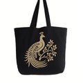 Black cotton tote bag with elegant gold peacock graphic design, reusable shoulder tote for shopping, travel, work, school, everyday carry, fashion accessories, and nature inspired style