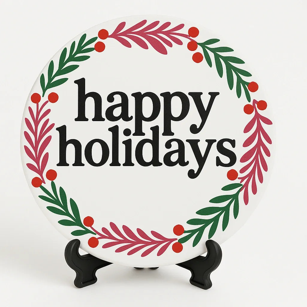 Holiday coaster featuring a decorative red and green wreath surrounding Happy Holidays text, perfect for Christmas and winter table decor.