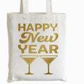 Happy New Year tote bag with gold lettering and champagne glass design on reusable white canvas shopping bag for New Year celebrations and holiday events.