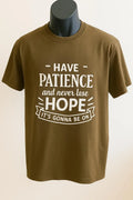 Brown graphic t-shirt featuring the inspirational message "Have Patience and Hope" in bold white typography. Motivational unisex shirt designed to encourage faith, positivity, perseverance, strength, and everyday inspiration.