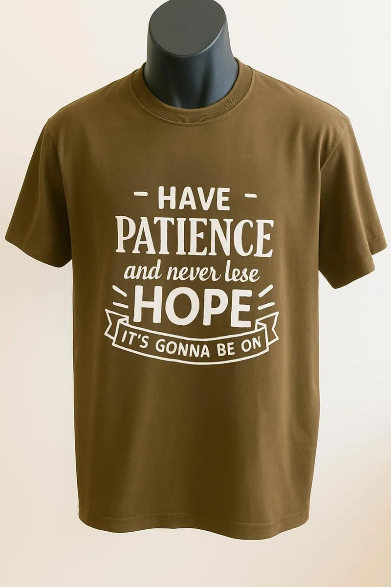 Brown graphic t-shirt featuring the inspirational message "Have Patience and Hope" in bold white typography. Motivational unisex shirt designed to encourage faith, positivity, perseverance, strength, and everyday inspiration.