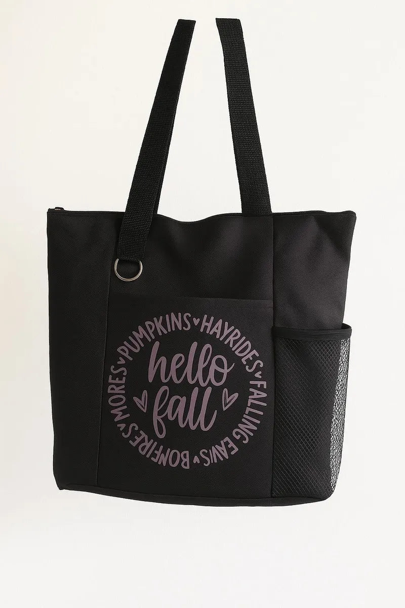 Black tote bag featuring a cozy "Hello Fall" seasonal design in autumn-inspired colors. Reusable fall-themed tote bag perfect for shopping, pumpkin patch visits, farmers markets, work, school, books, groceries, and everyday essentials. Lightweight and durable shoulder bag designed for autumn lovers and seasonal style.