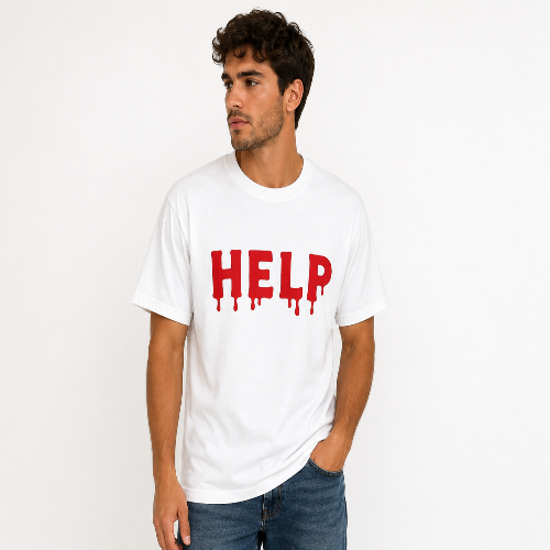 A man wearing a white crewneck t-shirt with the word 'HELP' printed in dripping red letters, paired with blue jeans, standing against a plain white background.