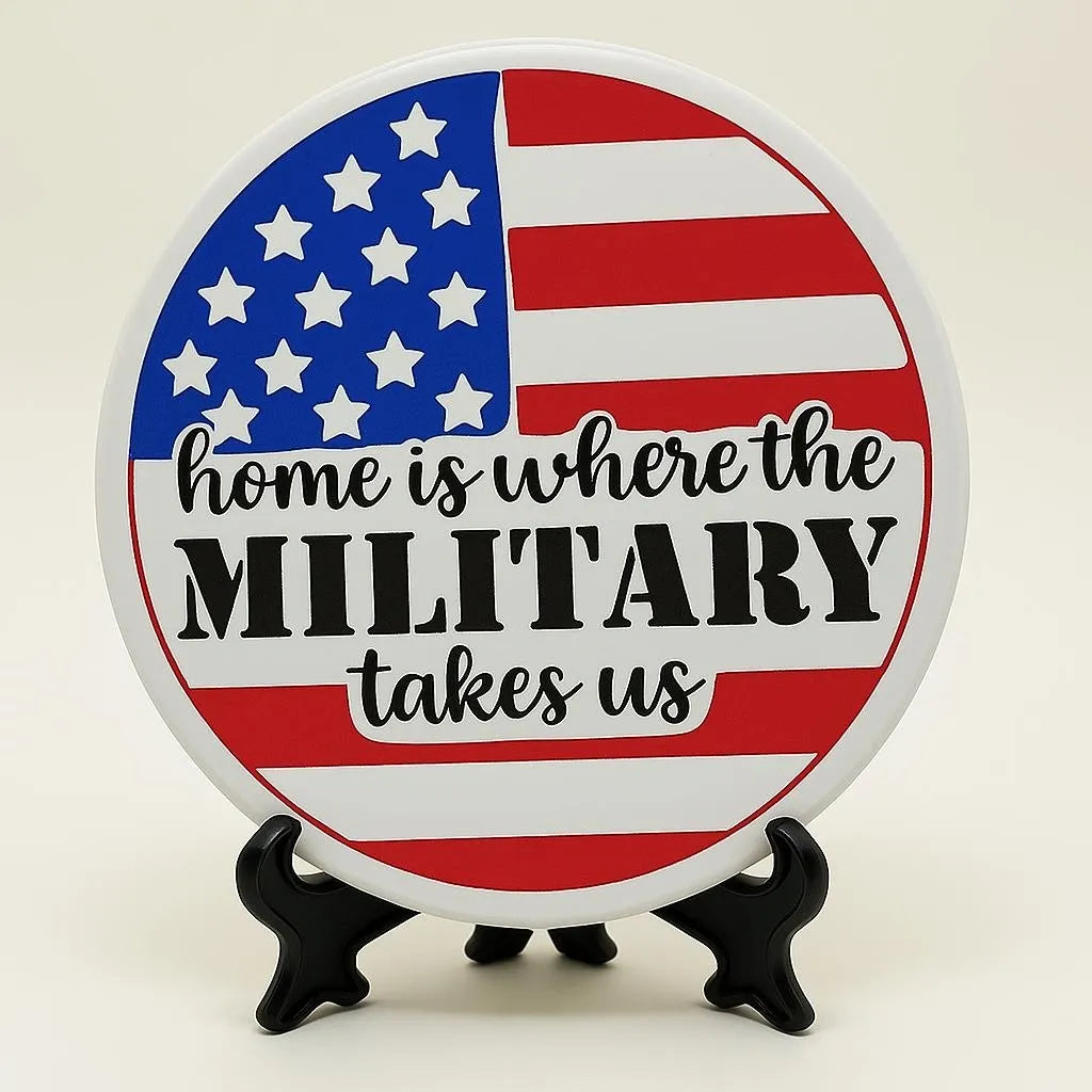 Round patriotic military coaster with American flag design and quote “Home Is Where the Military Takes Us,” decorative table coaster for military family home décor, veteran gift, patriotic coffee table accessory, red white blue farmhouse coaster, deployment homecoming gift, USA military decor accent for desk, dining table, office, and living room decoration.