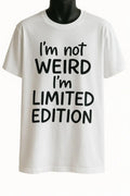 White graphic t-shirt featuring the quote "I'm Not Weird I'm Limited Edition" in bold black typography, inspirational unisex statement tee for everyday casual wear.