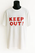 White graphic t-shirt featuring bold red "KEEP OUT!" text. Statement graphic tee with a clean, eye-catching design. Comfortable casual shirt perfect for streetwear, everyday outfits, weekend wear, travel, and anyone who enjoys bold typography fashion and expressive graphic apparel.