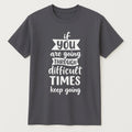 Dark gray graphic t-shirt featuring an inspirational Keep Going quote in white typography. Motivational unisex shirt designed for encouragement, positivity, perseverance, personal growth, and everyday casual wear