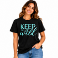 Woman wearing a black Keep It Wild graphic T-shirt with aqua teal lettering.