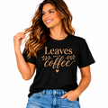 Leaves and Coffee black graphic T-shirt with warm brown lettering and leaf design styled with blue jeans.