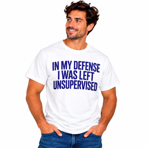 Man wearing a white In My Defense I Was Left Unsupervised graphic T-shirt with bold blue lettering.