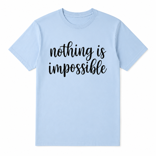 A light blue short-sleeve crewneck t-shirt with the phrase 'nothing is impossible' printed in black cursive text across the chest, displayed on a clean white background.