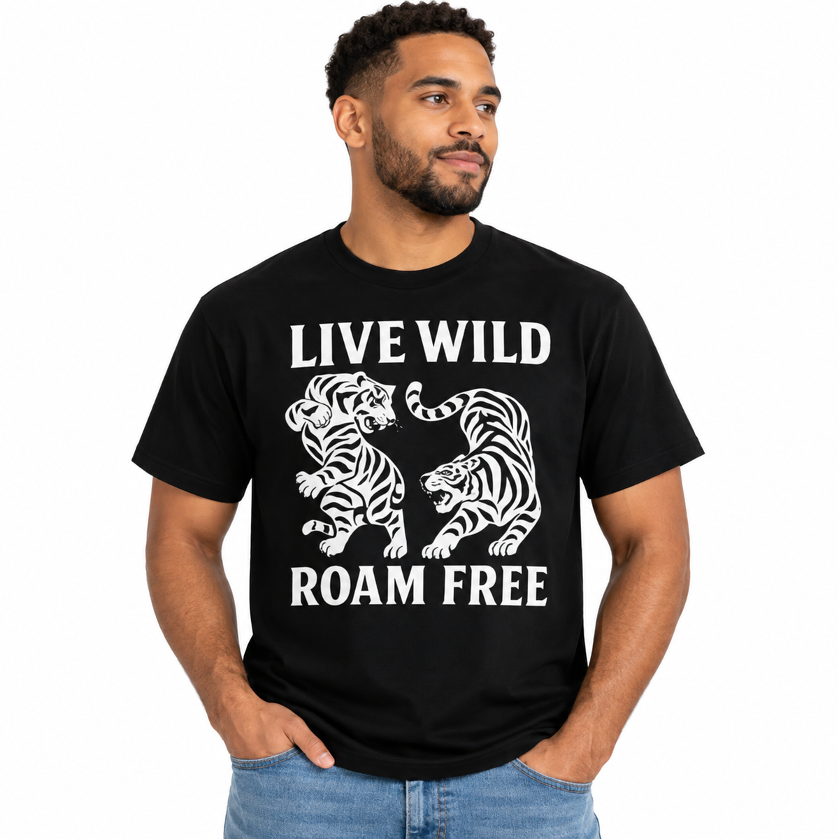 A man wearing a black short-sleeve t-shirt with a white graphic print of two roaring tigers and the text 'LIVE WILD ROAM FREE'.