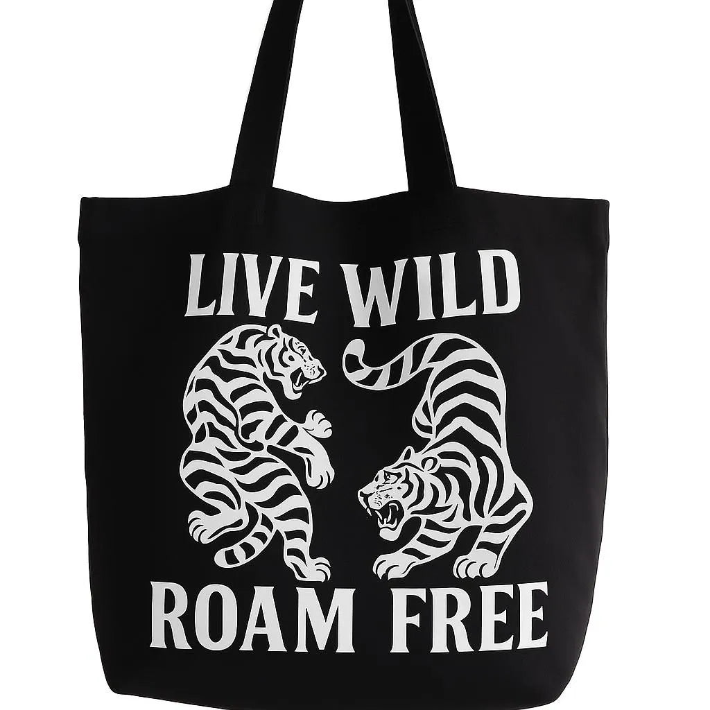 Black cotton tote bag with Live Wild Roam Free typography and tiger graphic design, reusable shoulder tote for travel, shopping, outdoor adventures, wildlife lovers, everyday carry, and nature inspired fashion