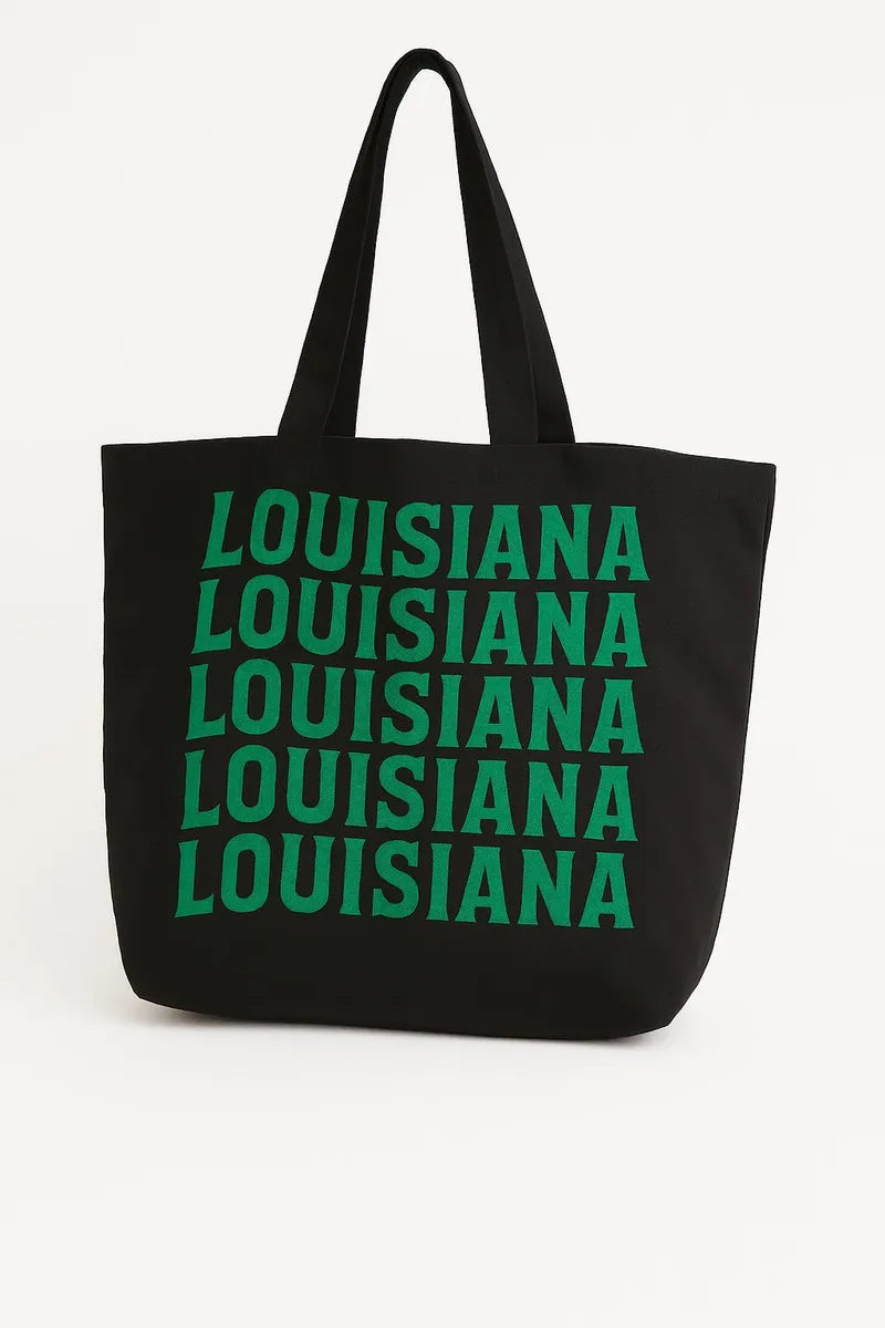 Black cotton tote bag with green Louisiana typography design, reusable state pride shoulder bag for shopping, travel, school, and everyday casual style.