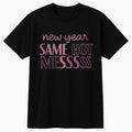 Black graphic t shirt featuring the phrase New Year Same Hot Mess in stylish pink typography, perfect for humor lovers, casual wear, and New Year celebrations.