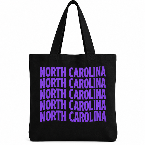 Black cotton tote bag with North Carolina repeated five times in bold purple lettering.