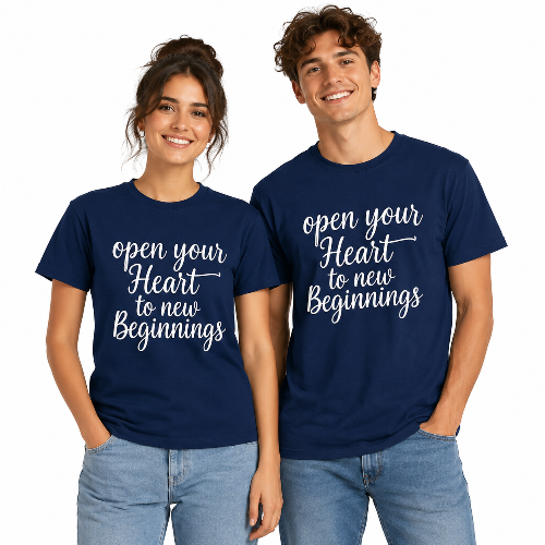 A man and a woman modeling matching navy blue t-shirts with white script text that reads 'open your Heart to new Beginnings' against a plain white background.
