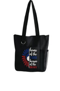 Black reusable tote bag featuring a patriotic USA design in red, white, and blue, lightweight shoulder tote for shopping, travel, groceries, books, holidays, and everyday carry