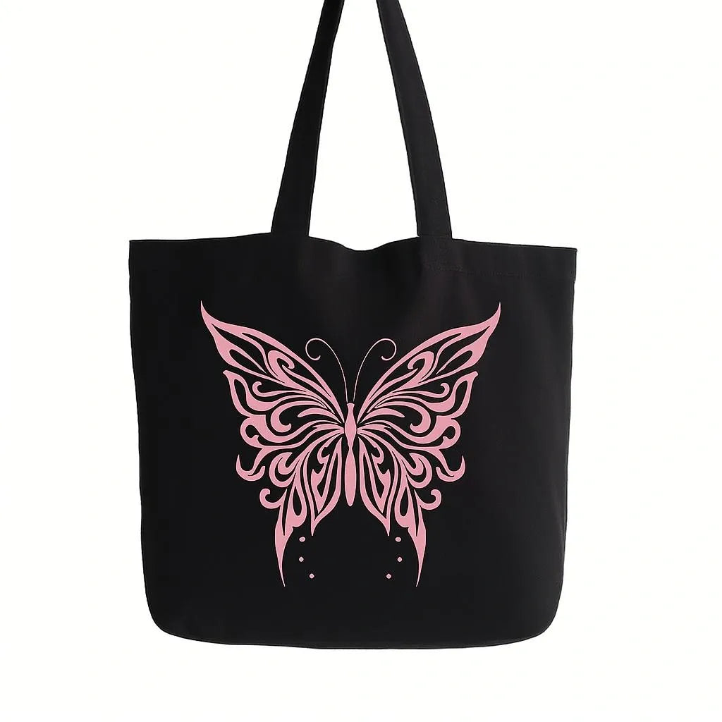 Black cotton tote bag with elegant pink butterfly graphic design, reusable shoulder tote for shopping, travel, work, school, everyday carry, nature lovers, and stylish fashion accessories