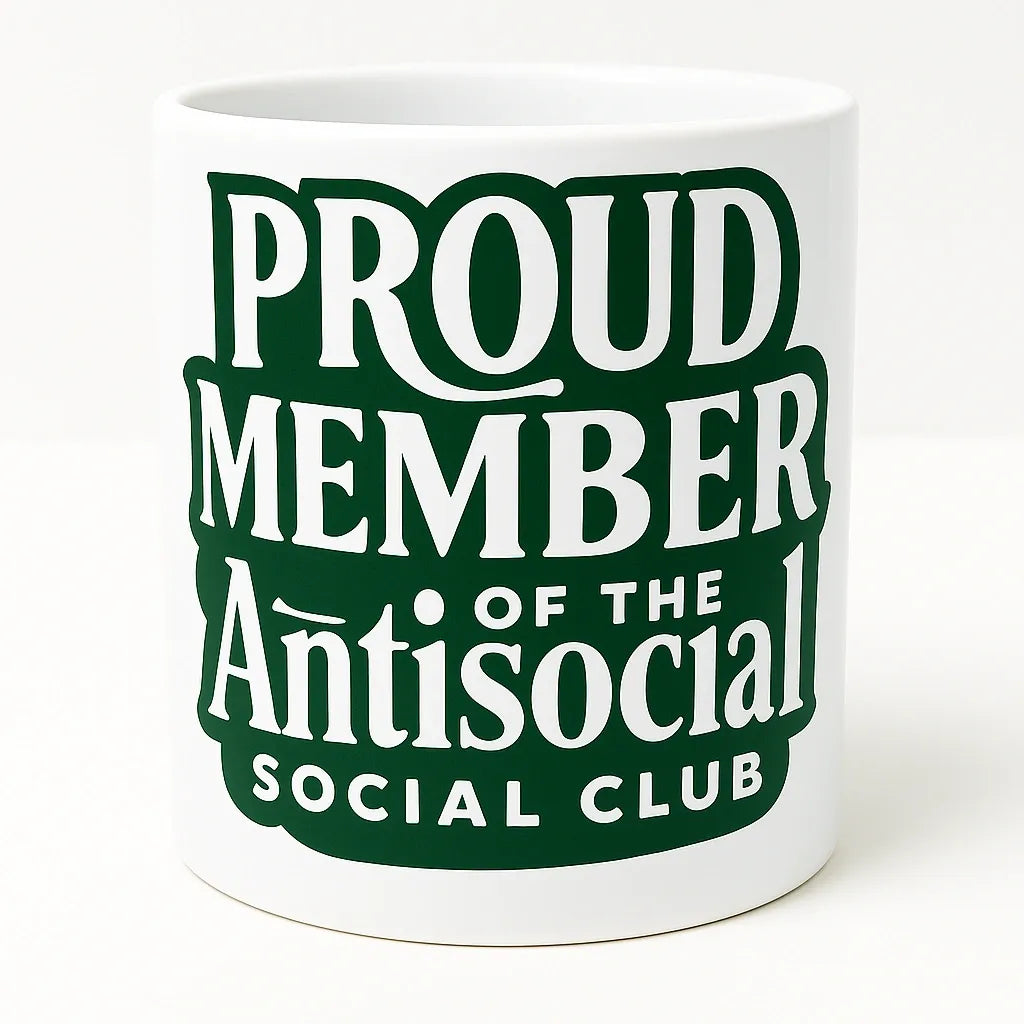 White ceramic mug featuring the phrase "Proud Member of the Anti Social Club" in bold green typography. Funny coffee mug perfect for introverts, homebodies, remote workers, coffee lovers, tea drinkers, and anyone who enjoys humor, sarcasm, and quiet time. Great for home, office, and daily use.