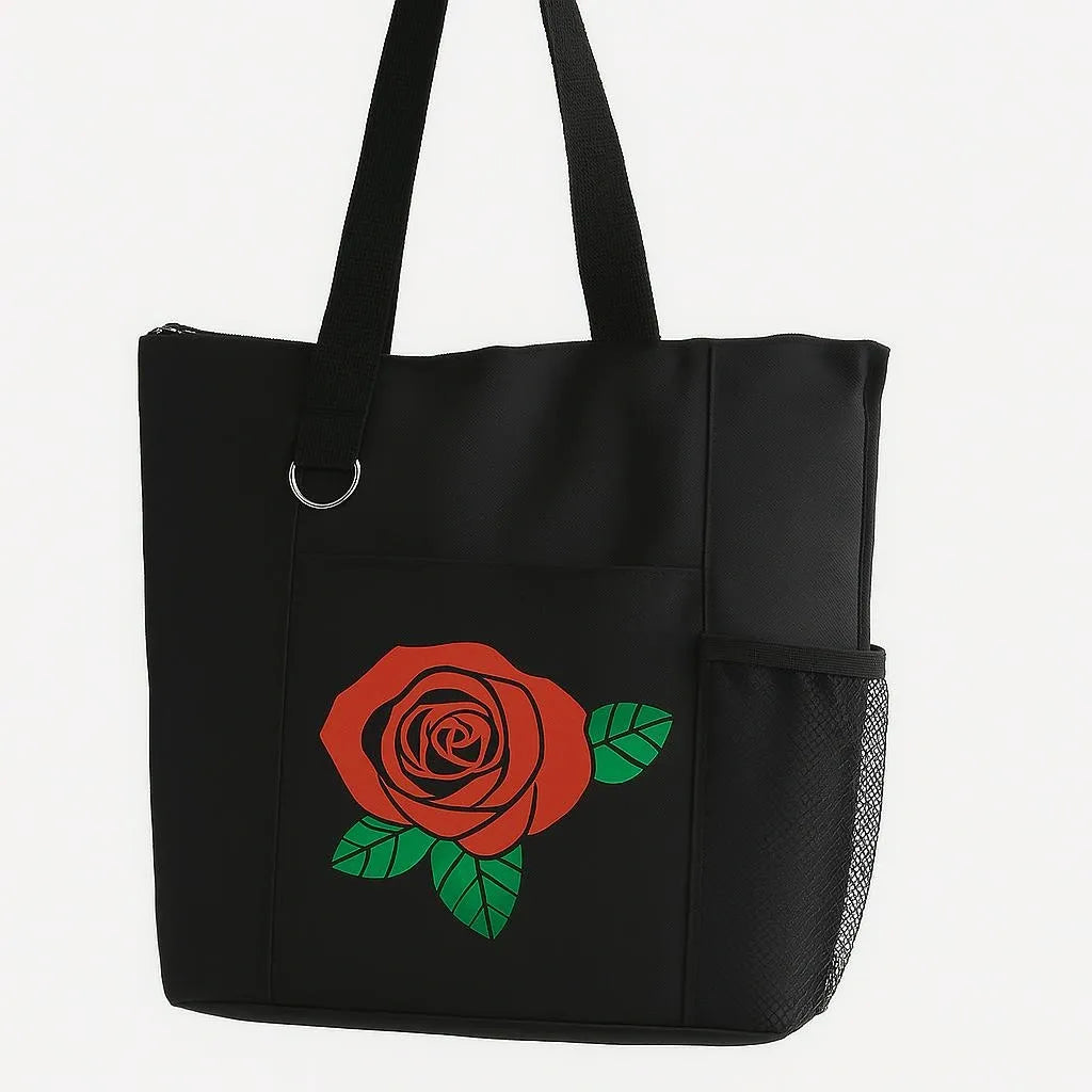 Black reusable tote bag featuring a red rose floral design with green leaves, stylish shoulder tote for shopping, travel, work, groceries, books, everyday carry, floral gift bag, and casual fashion accessory